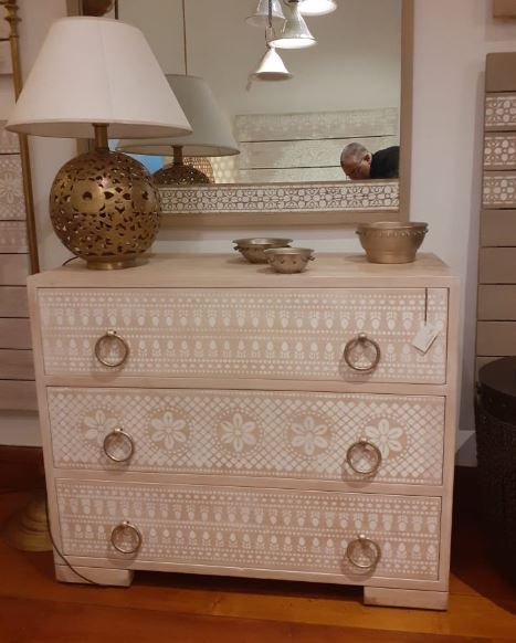 Stencil Chest of Drawers With Decorative White Patterns 0